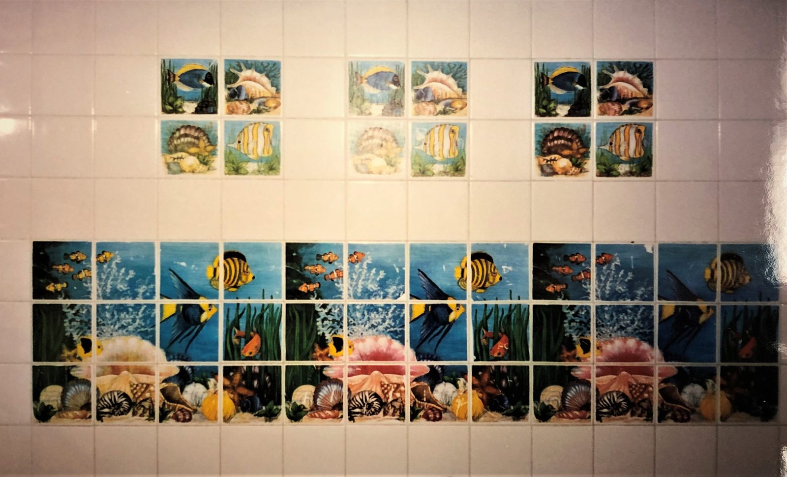 Decorative ocean-themed tile art in a WRC shelter bathroom.